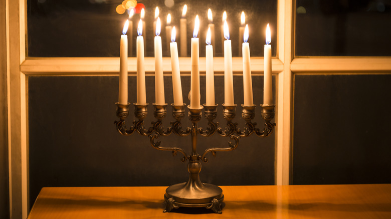 Brass menorah by window