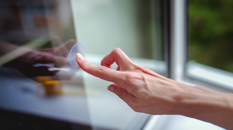 Woman sticking on window decal 