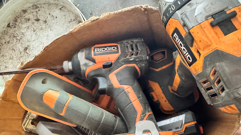 Several power tools stored in a cardboard box