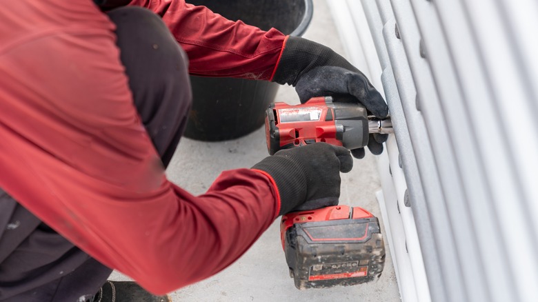 Person using a cordless impact wrench