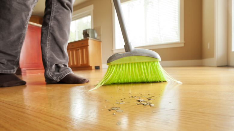 Person sweeping hardwood