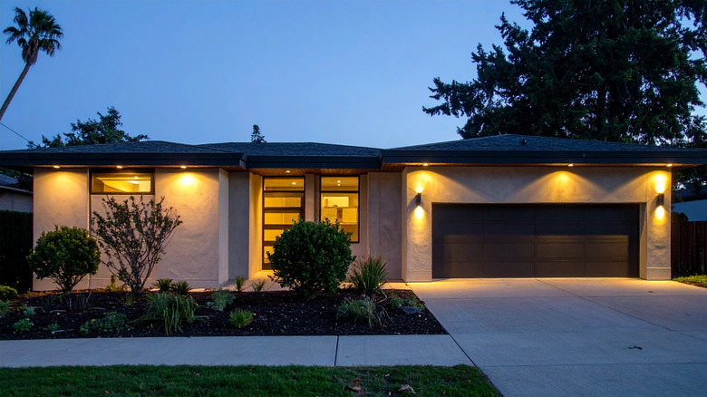 A modern home with warm exterior lighting