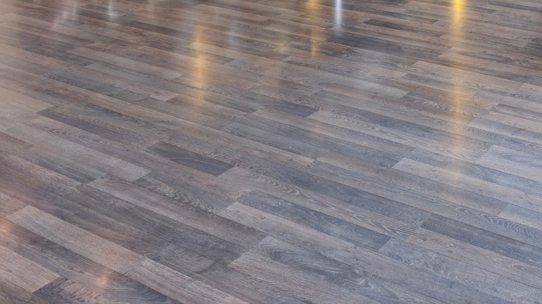 Glossy, narrow, gray vinyl plank floor