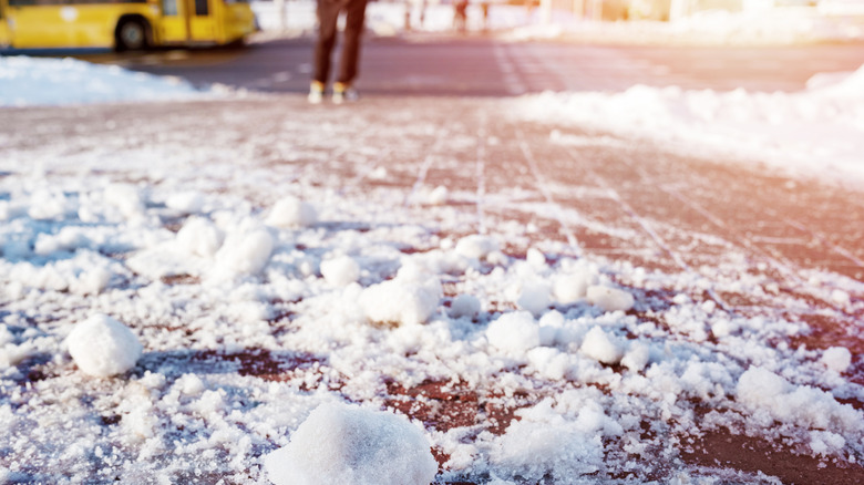 Chunks of snow on a paver driveway