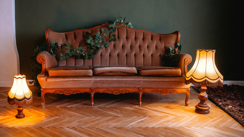 Vintage lamps sitting next to vintage couch