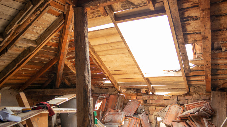 An attic space with water-damaged roof boards