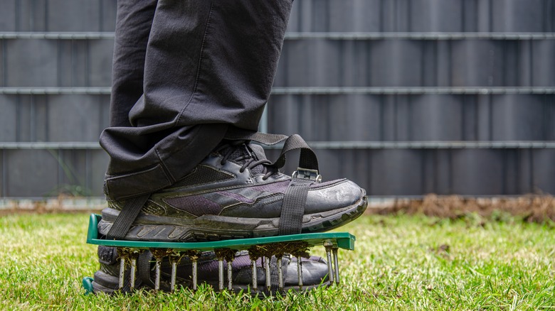 Close-up of lawn aerating shoes with metal spikes