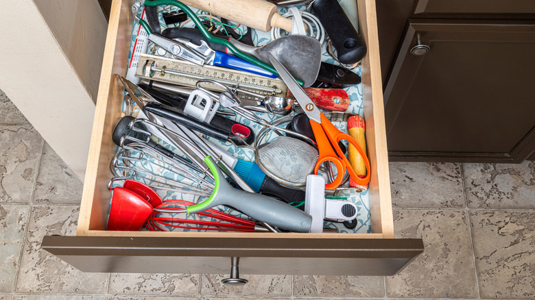 A junk drawer full of plastic bags of miscellaneous items