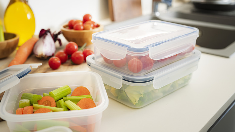 Airtight plastic food containers filled with vegetables on kitchen counter