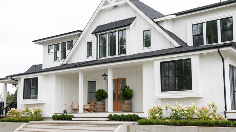 white farmhouse with black roof