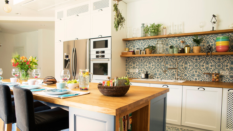 Mediterranean kitchen with tile backsplash