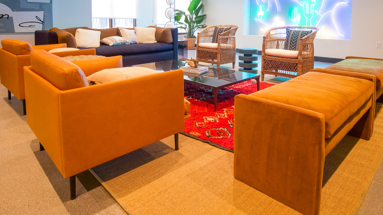 orange armchairs and red rug