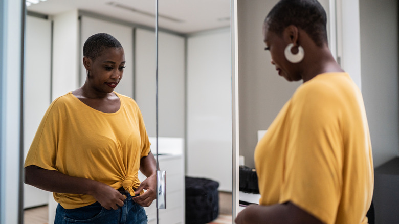 Woman trying on clothes at home