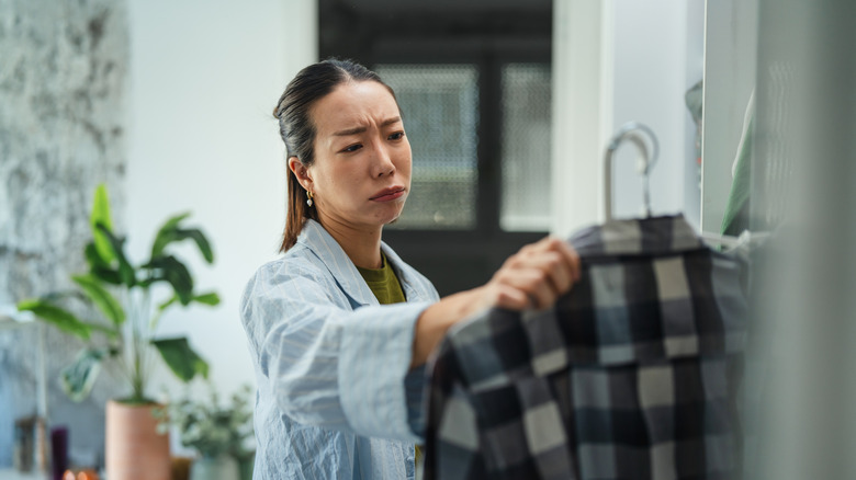 Woman frowning at checkered shirt