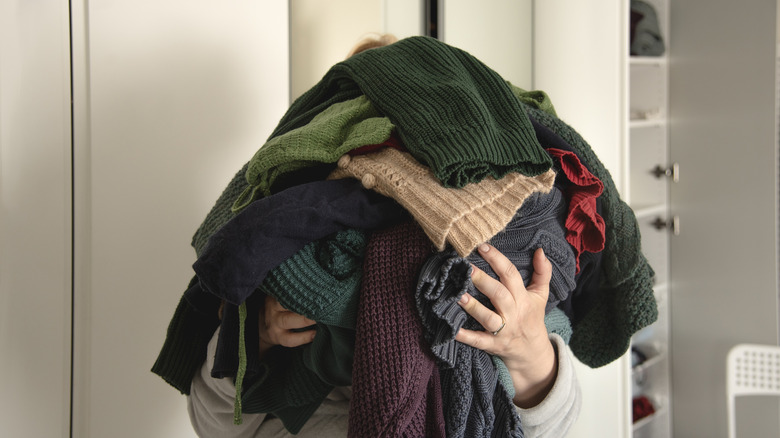 Person decluttering closet