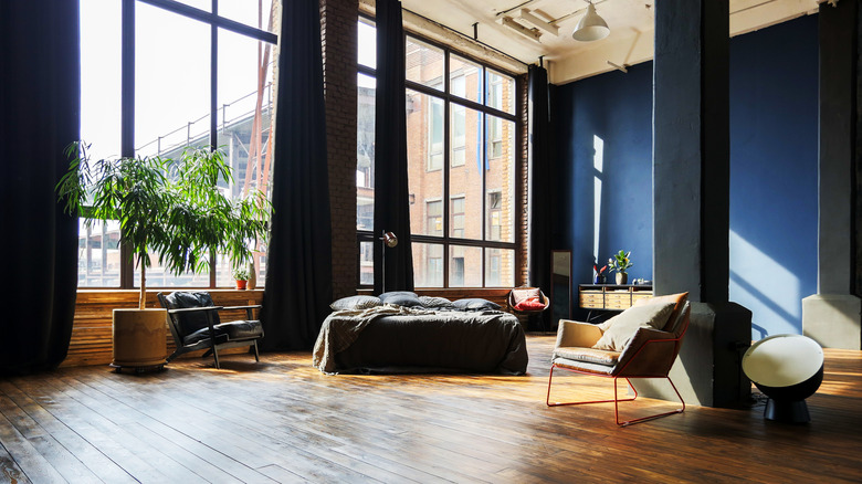 loft space with large windows and blue walls