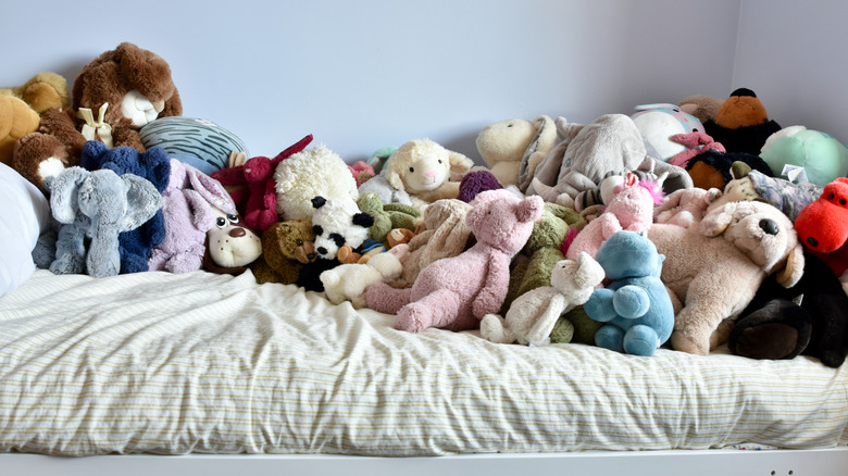 A collection of children's stuffed animals on a bed