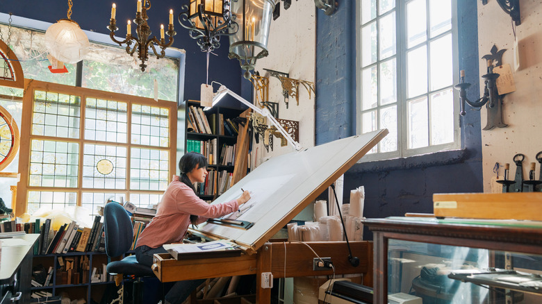 Person drawing at a drafting table
