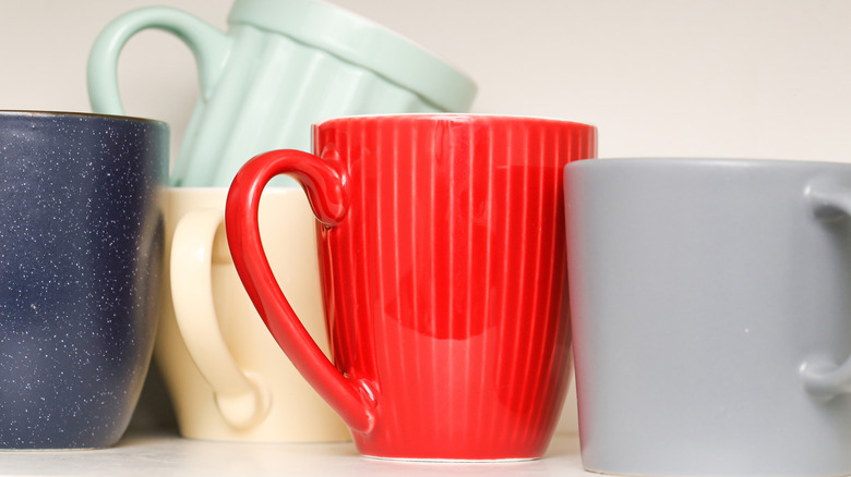 Selection of colorful mugs on a surface
