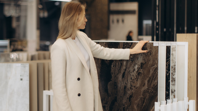A woman shopping for bold marble surfaces.