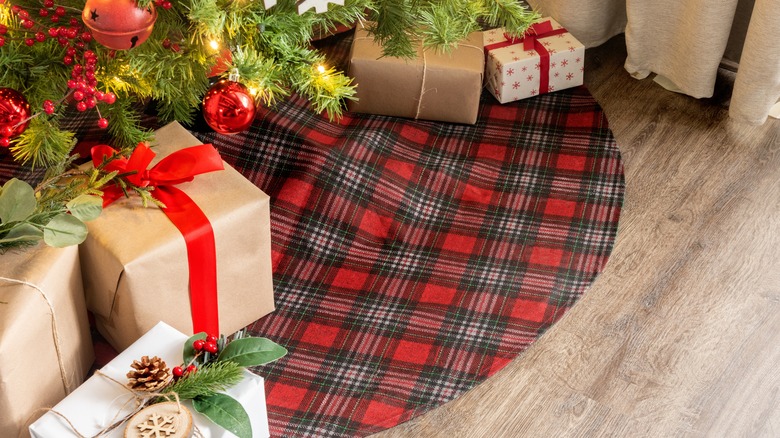 Plaid Christmas tree skirt with gifts under a decorated tree