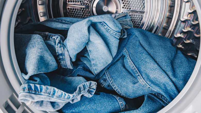 denim clothing in the drum of a tumble dryer
