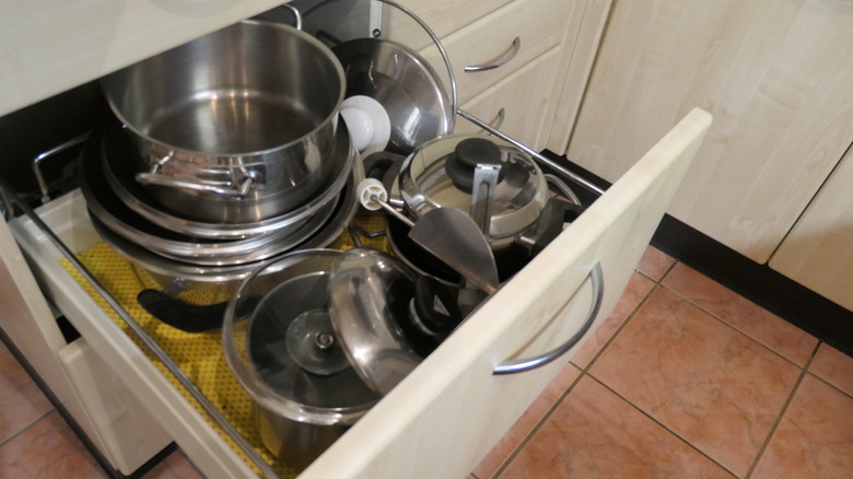 cluttered kitchen drawer pots pans