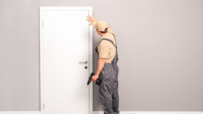 man fixing door