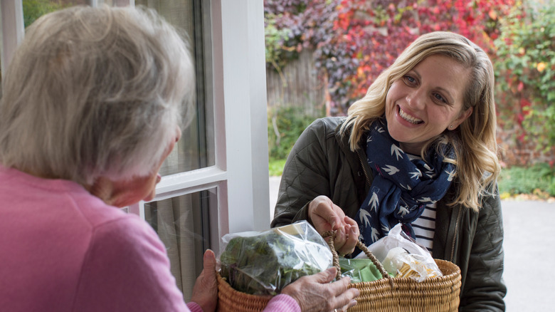 Woman smiling at elderly woman