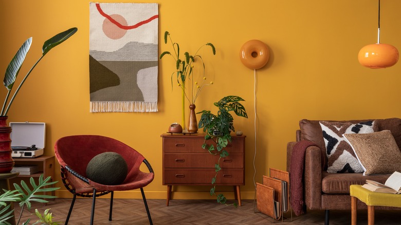 Yellow painted room with red chair and accents