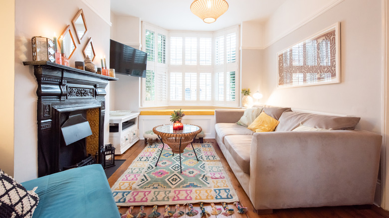 Neutral living room featuring a brightly colored rug