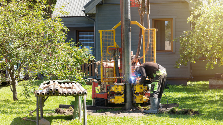A person working on digging a well for an off-grid home