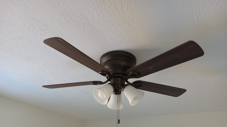 Person turning on ceiling fan