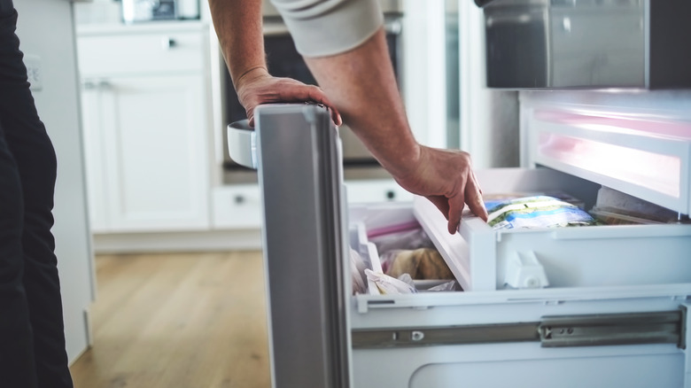 Person opening freezer