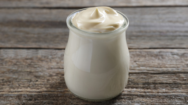Small jar of mayo on wood table