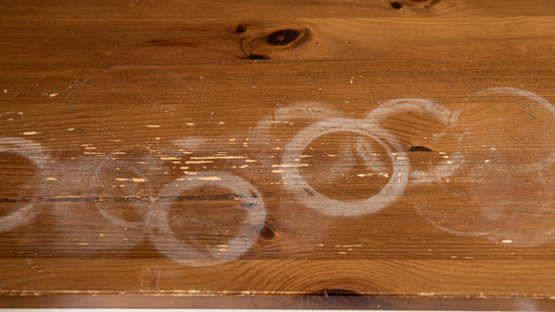 White water rings on stained pine tabletop