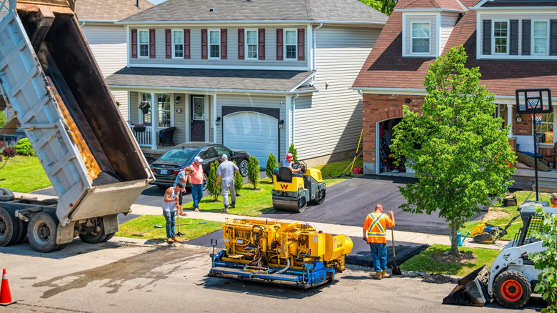 Workers installing a new asphalt driveway