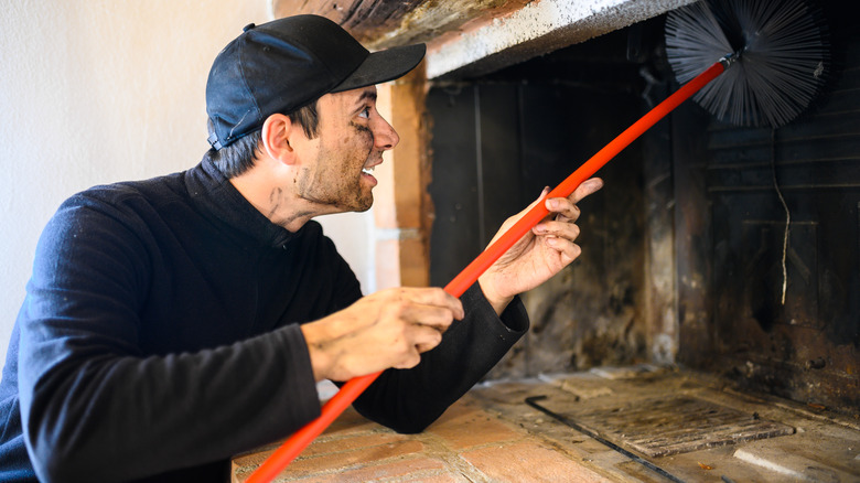 Chimney sweeper cleaning chimney