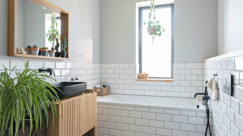 A modern white, minimalist bathroom is full of light.