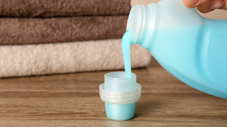 person pouring fabric softener