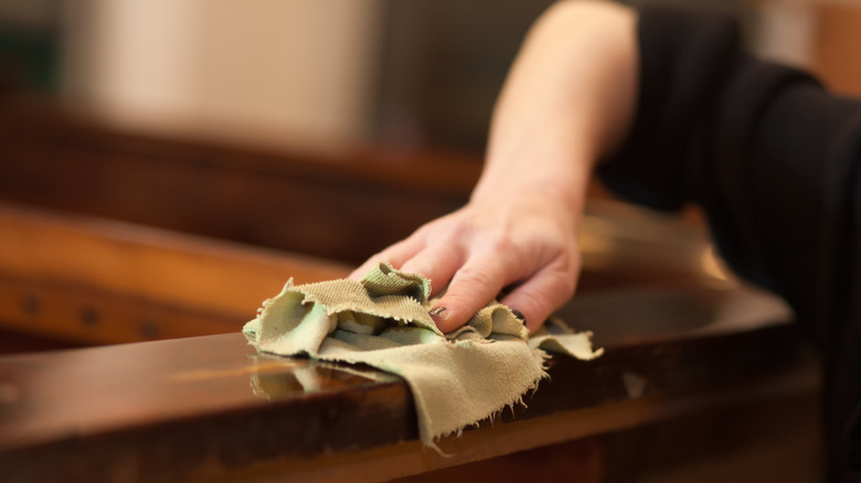 woman polishes wood