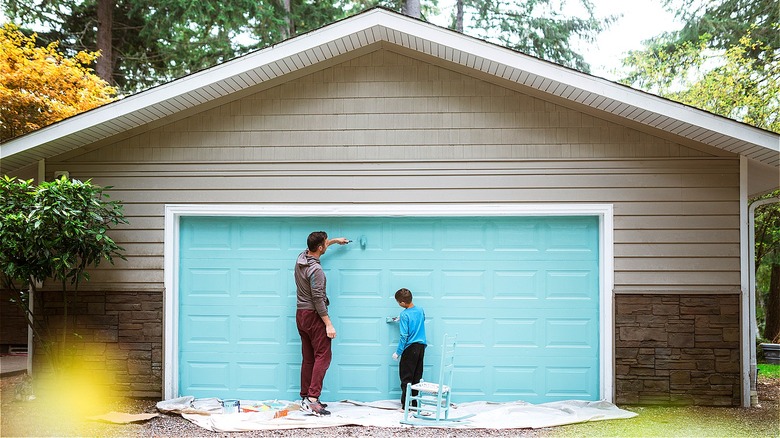 Father and son painting house