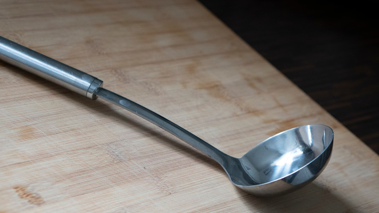 Silver soup ladle on countertop