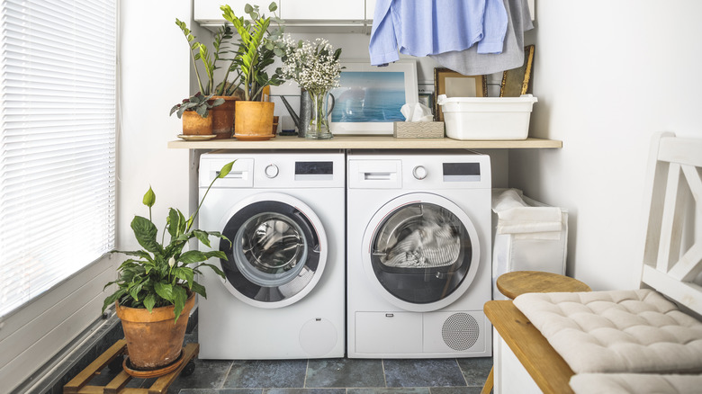 Laundry room with washer and dryer and a counter over them