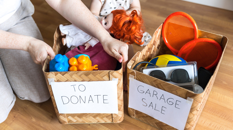 person decluttering toys in donate and garage sale bins
