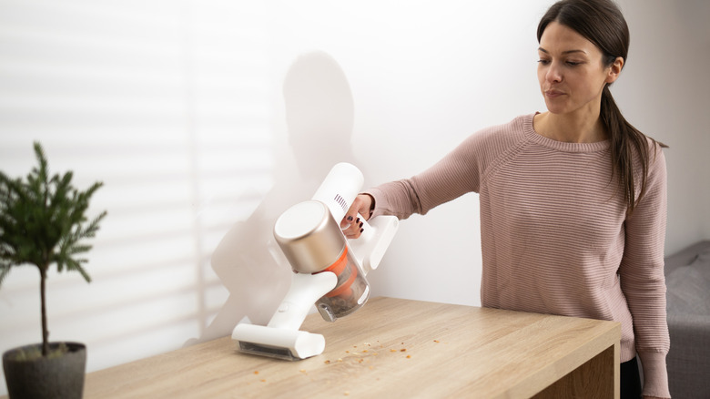 woman vacuuming crumbs