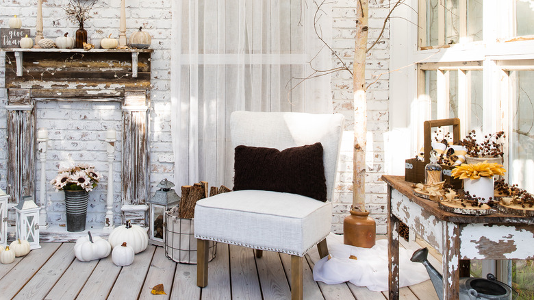 room full of white and brown chipped finished furniture and new furniture with fall decor