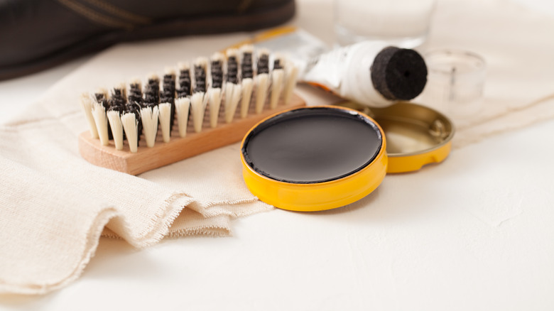 shoe polish and scrubbing brush 