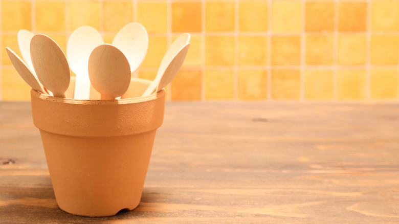 kitchen counter with wooden spoons in flower pot