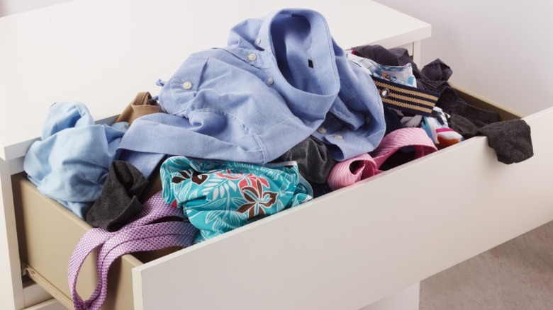 dresser drawer overloaded with clothes